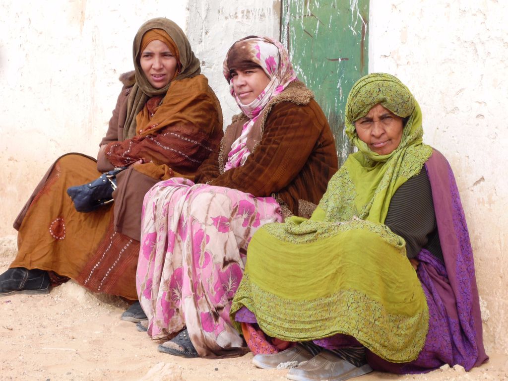 Three women sitting down. The women are Sahrawi refugees.