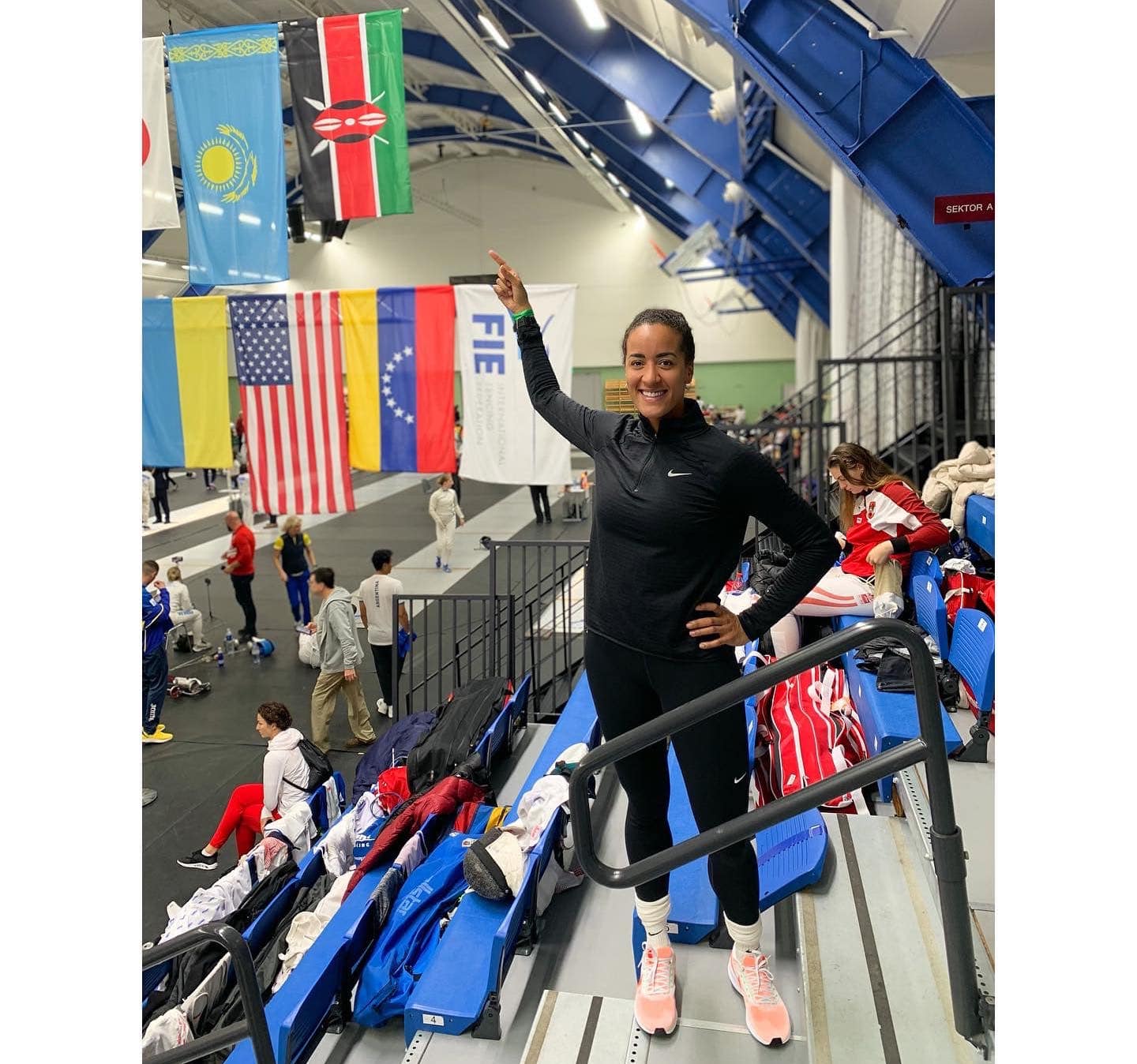 Alexandra Ndolo points at the Kenyan flag.
