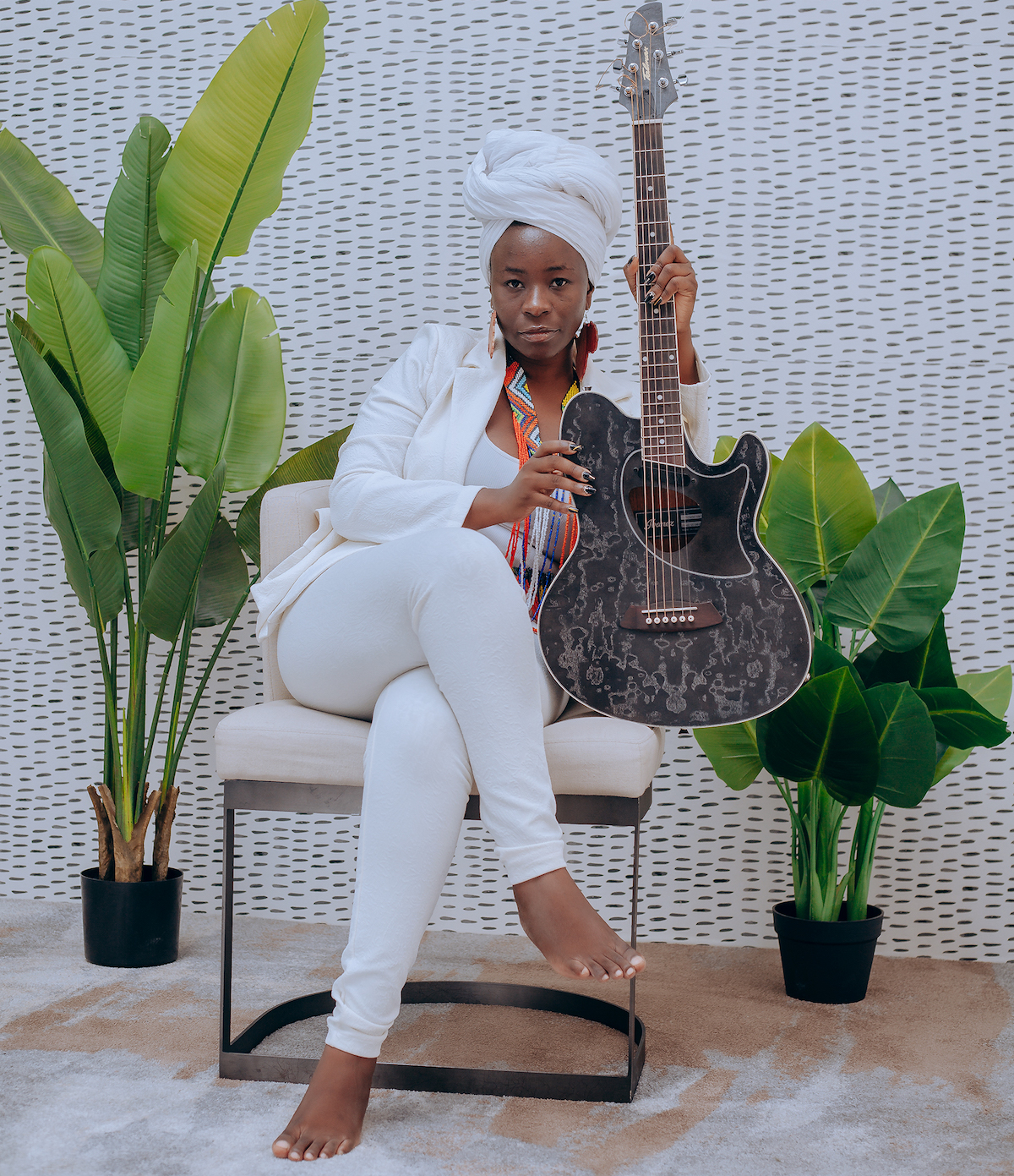 Wezi is a Zambian singer, songwriter and rights advocate.