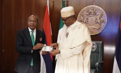 Nigerian president Muhammadu Buhari and Godwin Emefiele, the governor of the Central Bank of Nigeria, present the redesigned banknotes in Abuja.
