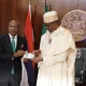Nigerian president Muhammadu Buhari and Godwin Emefiele, the governor of the Central Bank of Nigeria, present the redesigned banknotes in Abuja.