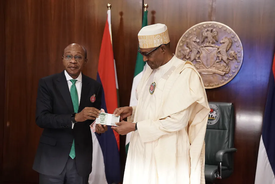 Nigerian president Muhammadu Buhari and Godwin Emefiele, the governor of the Central Bank of Nigeria, present the redesigned banknotes in Abuja.