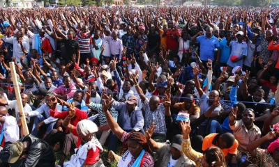 Supporters of Tanzania’s main opposition party Chadema wave during a rally in Mwanza