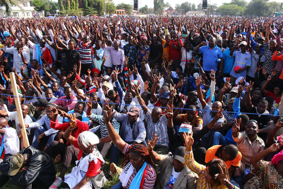 Supporters of Tanzania’s main opposition party Chadema wave during a rally in Mwanza