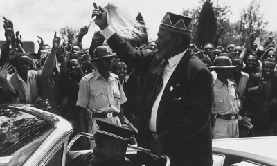 Kenya’s first president Jomo Kenyatta waves at a crowd.