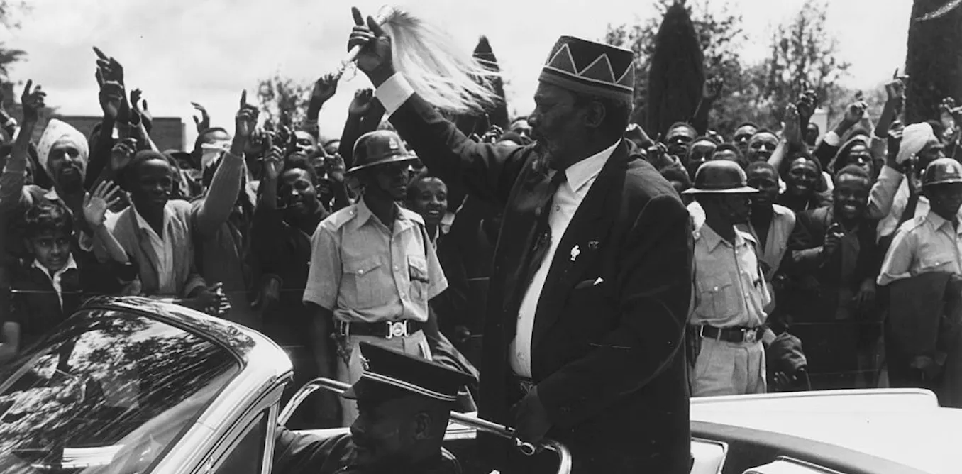 Kenya’s first president Jomo Kenyatta waves at a crowd.