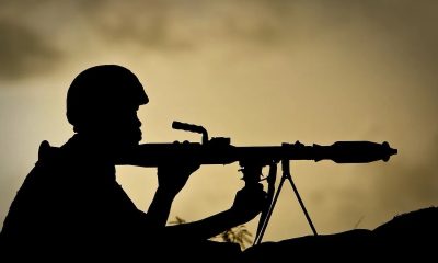 A Ugandan soldier of 341 Battalion serving with the African Union Mission in Somalia (AMISOM) holds a rocket-propelled grenade at sunrise 30 April 2012.
