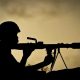 A Ugandan soldier of 341 Battalion serving with the African Union Mission in Somalia (AMISOM) holds a rocket-propelled grenade at sunrise 30 April 2012.