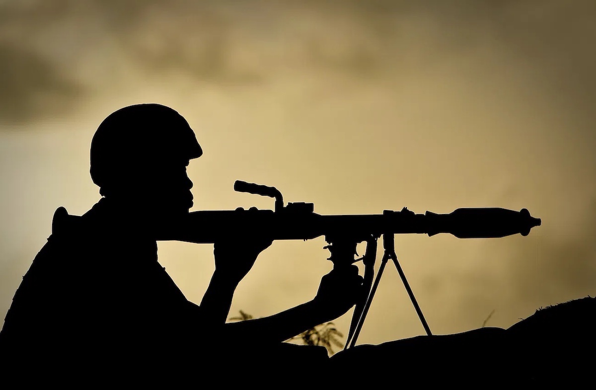 A Ugandan soldier of 341 Battalion serving with the African Union Mission in Somalia (AMISOM) holds a rocket-propelled grenade at sunrise 30 April 2012.