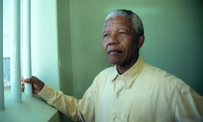 Nelson Mandela revisiting his cell at Robben Island prison. The image was sold to support his charitable causes. Louise Gubb/Corbis via Getty Images