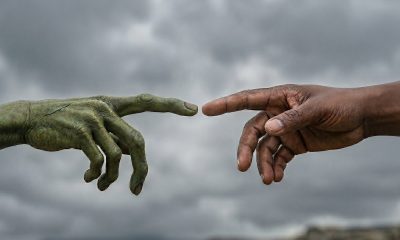 An AI generated depiction of an imagined hand of an Extra terrestrial being and a human hand.
